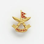 A pin with an emblematic design, featuring a red and white color scheme with a symbol in the center, placed on a white textured surface.