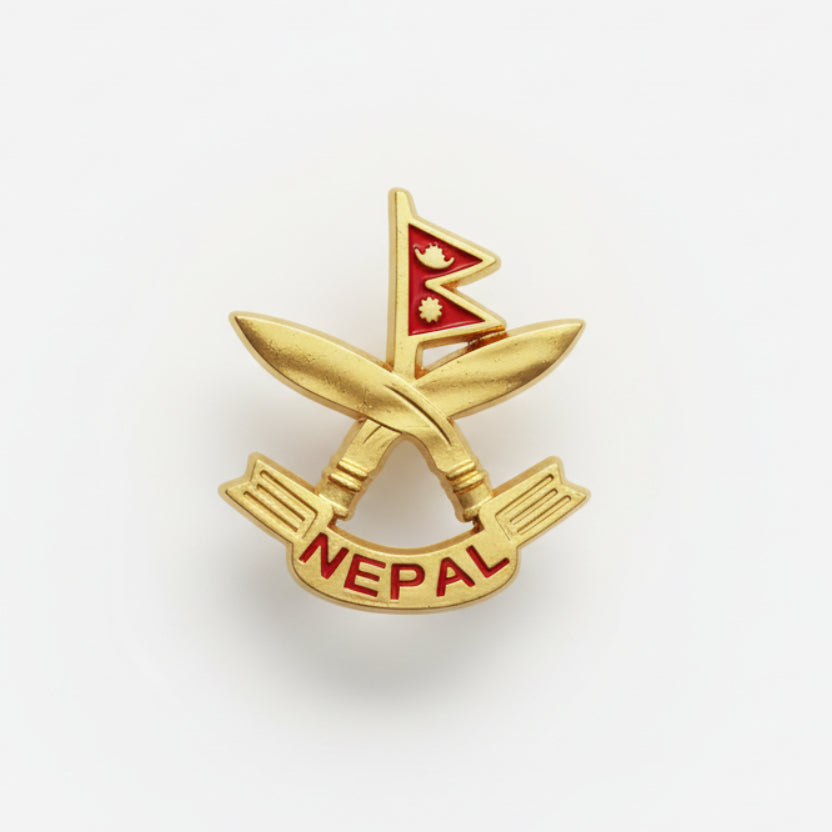 A pin with an emblematic design, featuring a red and white color scheme with a symbol in the center, placed on a white textured surface.