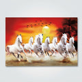 A rectangular wall art print or poster showing a group of white horses galloping across a desert landscape at sunset, with a large yellow sun, red-orange sky, birds, and palm trees. The print is photographed against a light gray surface.