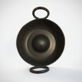 Black metal bowl with handle on a white background