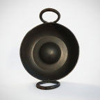 Black metal bowl with handle on a white background