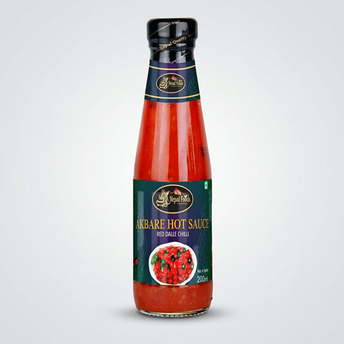 Bottle of Akbare Hot Sauce with a visible brand logo on a white background