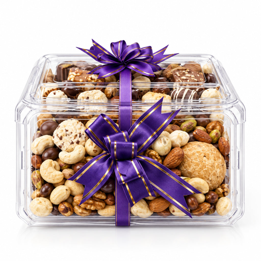 A clear plastic gift box filled with assorted nuts, chocolates, and cookies, tied with a large purple satin bow with thin gold stripes, on a white background.