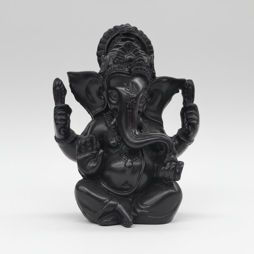 Black decorative figure of a person on a horse against a blurred indoor background