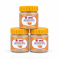 Three small jars of Shri Swaad Sandalwood Powder arranged in a pyramid stack on a white surface, with a blurred indoor background.