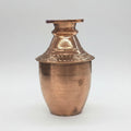Copper vase with textured design on a white background