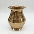 Gold vase with ribbed texture on a white background