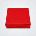 A stack of four folded red fabric tablecloths on a solid white background.