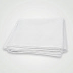 A folded bright yellow fabric item, likely a tablecloth or sheet, shown on a plain white background.