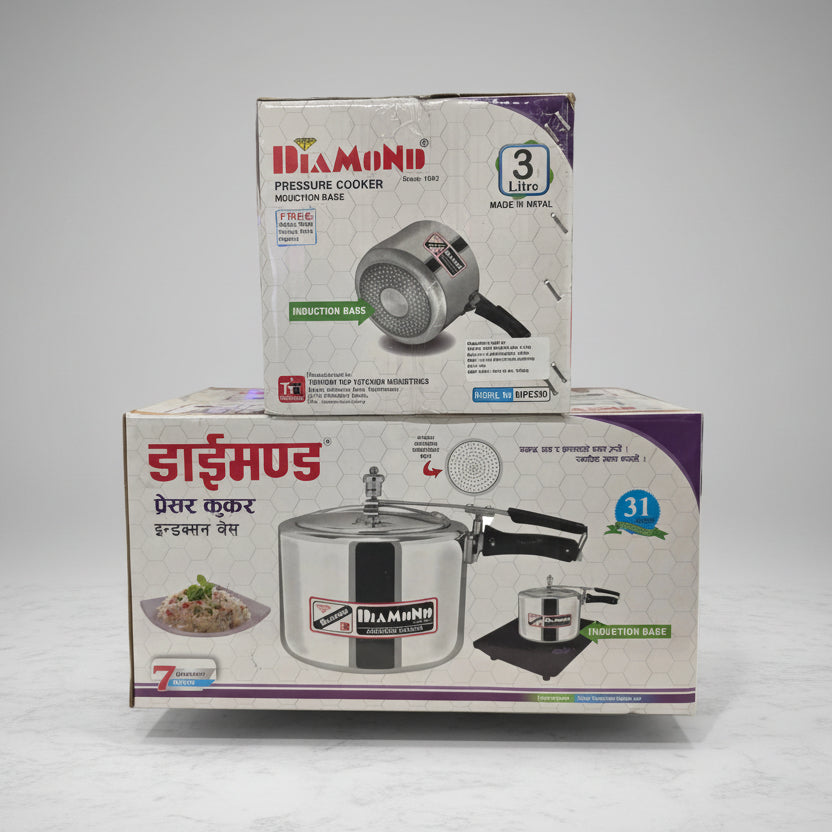 Two pressure cooker boxes with brand logos on a blurred background