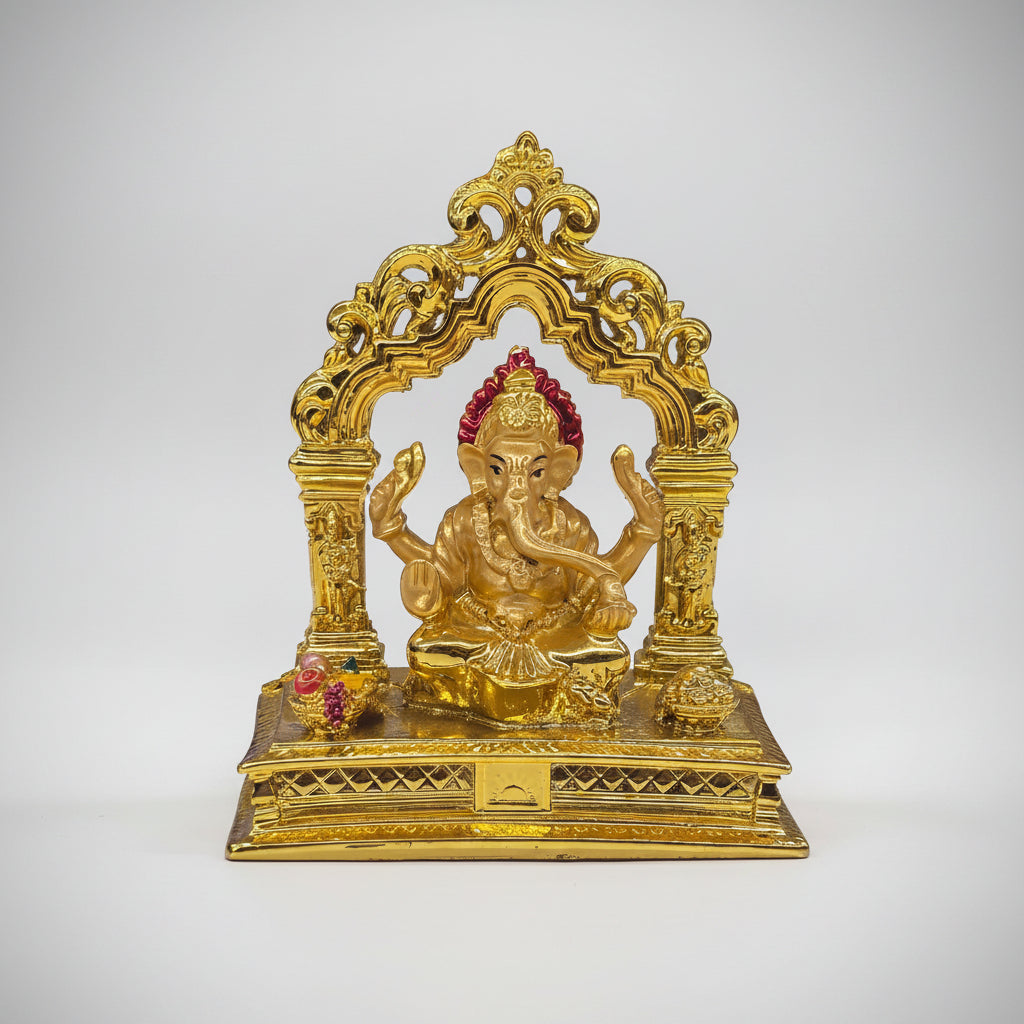 Gold-colored decorative statue on a white surface with blurred shelves in the background