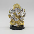 Decorative motorcycle figurine in gold and silver on a white background