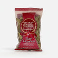 Packaged bay leaves in a transparent plastic bag with a red and white label, featuring the brand Heera.