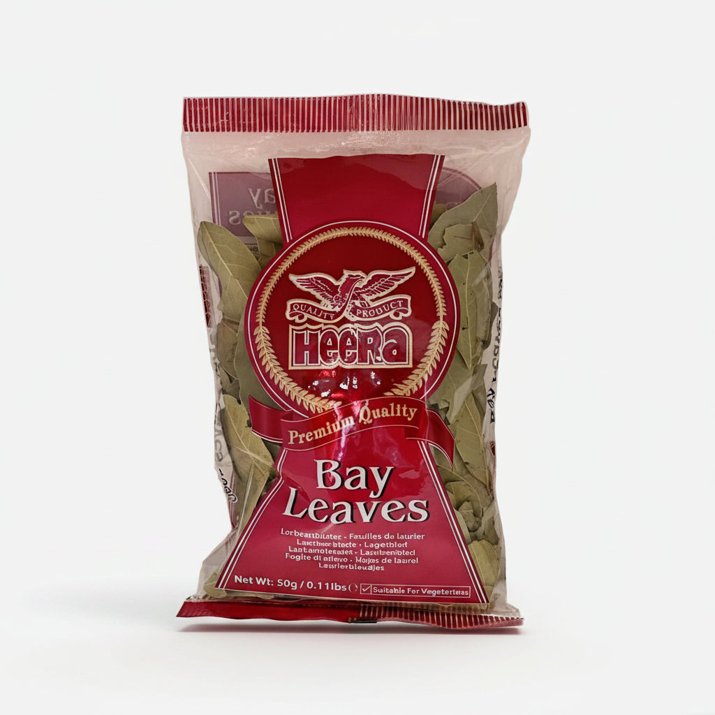 Packaged bay leaves in a transparent plastic bag with a red and white label, featuring the brand Heera.