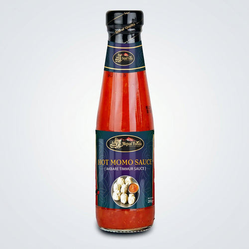 Bottle of Hot Momo Sauce with a blue label on a white background