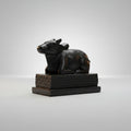 Black bull figurine on a white background