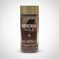Nescafe Gold instant coffee jar on a white surface with a blurred background