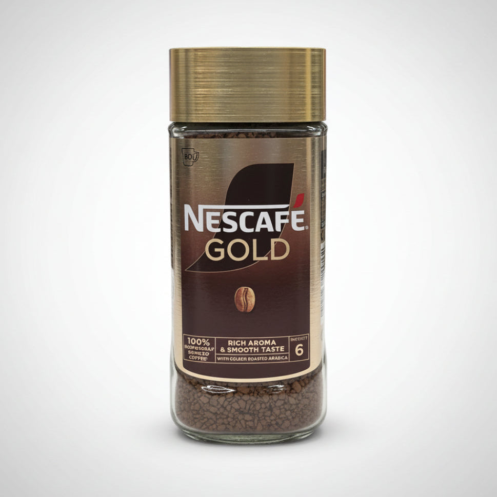 Nescafe Gold instant coffee jar on a white surface with a blurred background