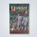 A rectangular illustrated book or booklet cover titled in Devanagari script, featuring an elephant, rabbit, monkey, and other animals in a forest scene, photographed against a light gray surface.