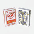 Two boxes of playing cards, one red and white with 'Bin Wang' branding, the other blue and white with intricate design, on a light surface.