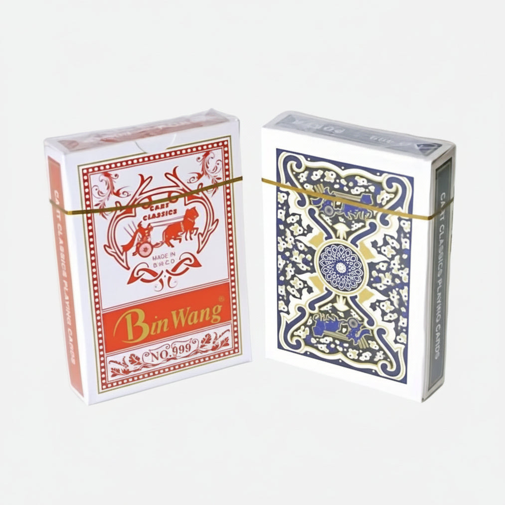 Two boxes of playing cards, one red and white with 'Bin Wang' branding, the other blue and white with intricate design, on a light surface.