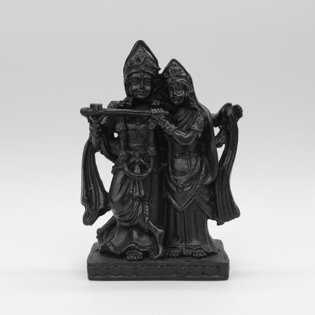 Black decorative wall sculpture against a blurred bookshelf background