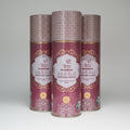 Three cans of 'Jadi But' Ayurvedic hair oil stacked on a white surface.