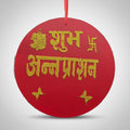 Red circular ornament with gold text and decorative elements on a white background