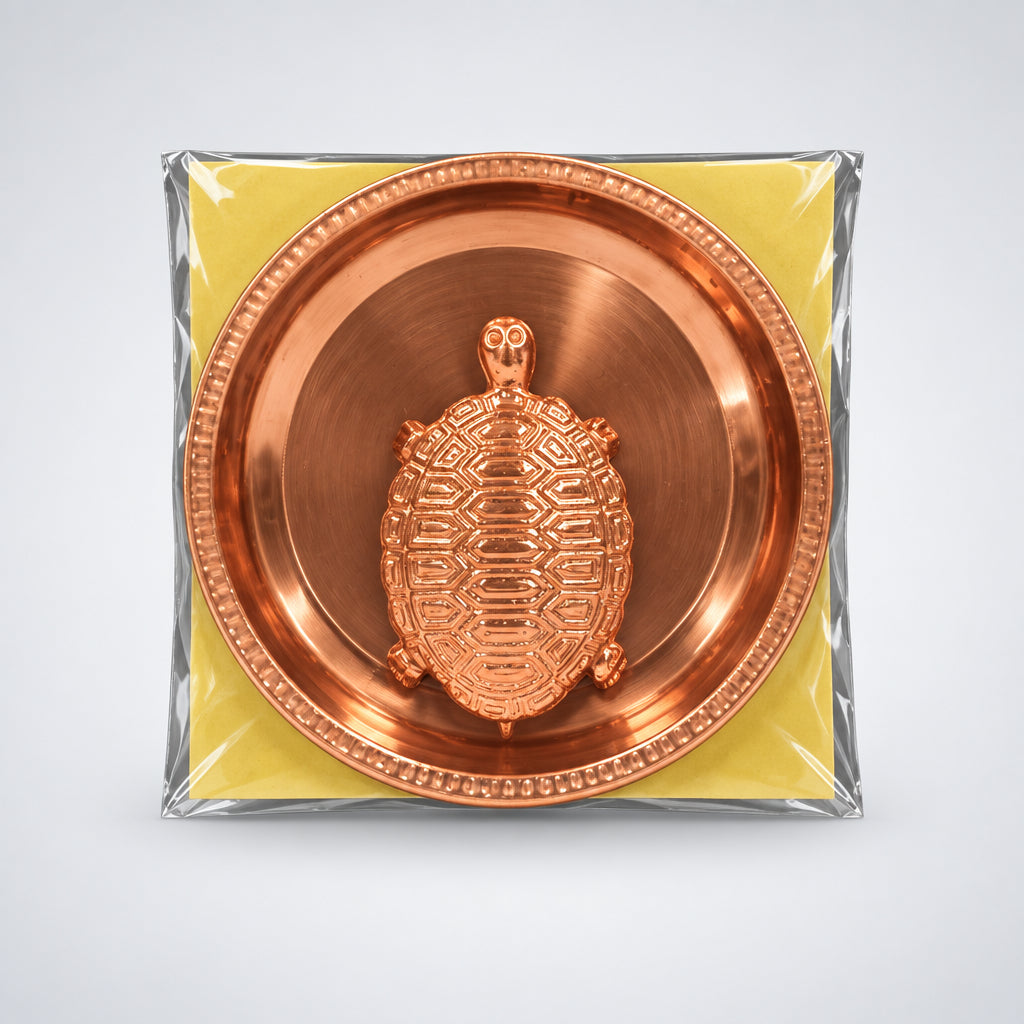 Copper turtle amulet in a clear plastic bag on a white background