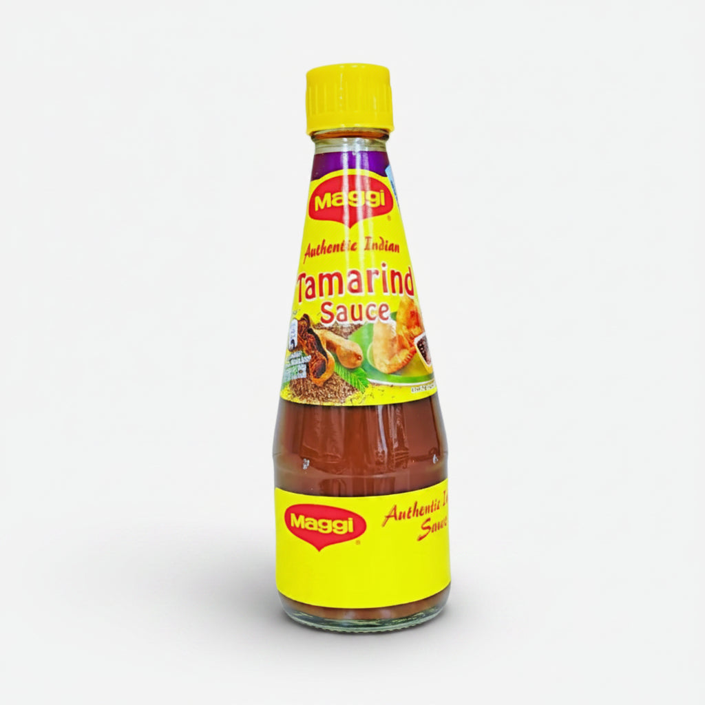 A bottle of Maggi Tamarind Sauce with a yellow label on a white background.