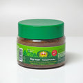 Jar of timur powder with green lid and label on a white background