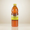 Bottle of TRS Pure Mustard Oil on a white background