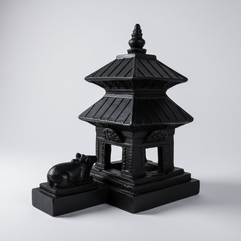 Black pagoda-like structure with a small animal figure on a white background, featuring the 'nepsto' brand.