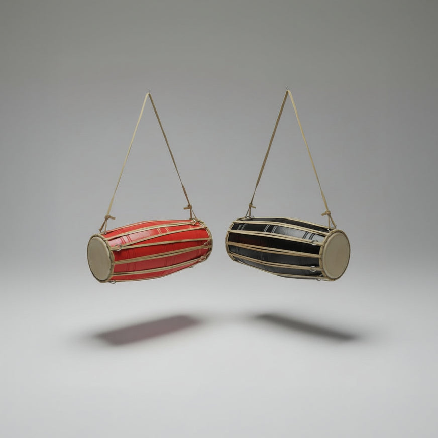 A traditional red hand drum (Madal) with a cylindrical shape, suspended by a strap against a white background.