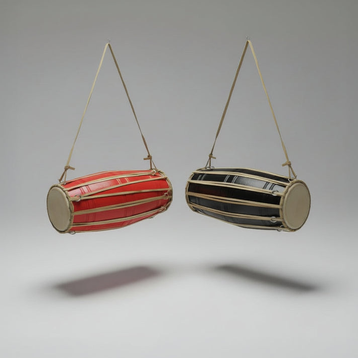 Two hanging cylindrical drums, one red and one black and gold, on a gray background.