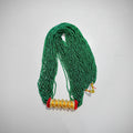 A green beaded necklace with gold-colored accents on a white background.