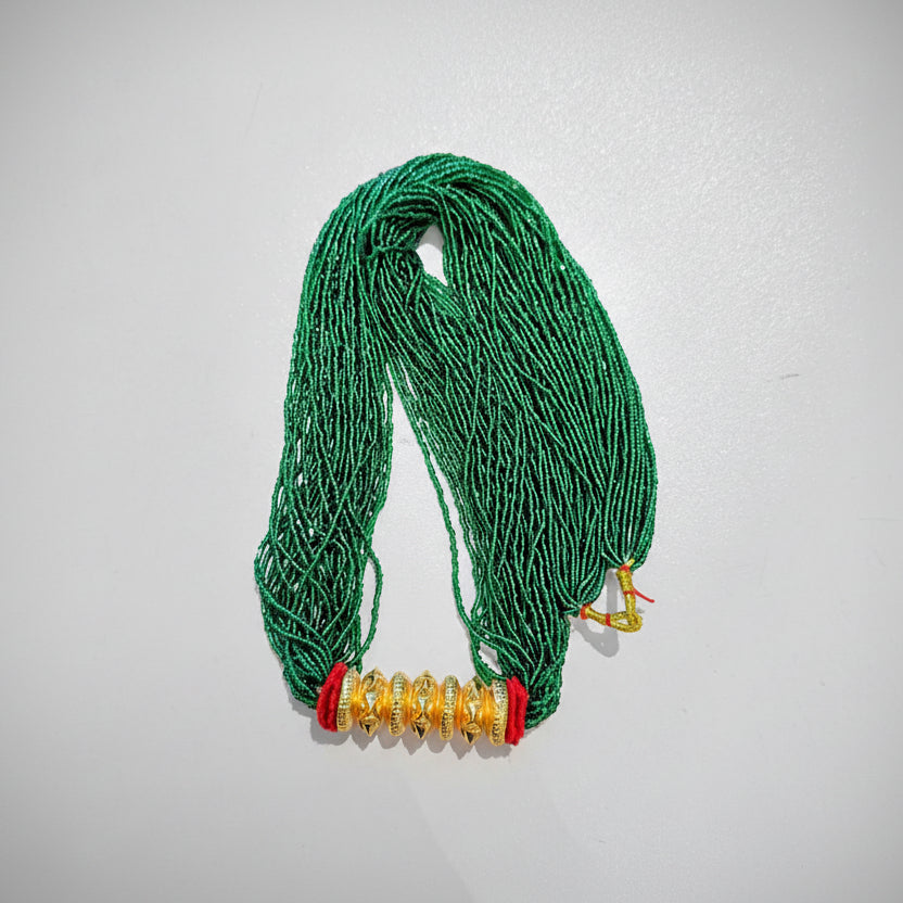 A green beaded necklace with gold-colored accents on a white background.
