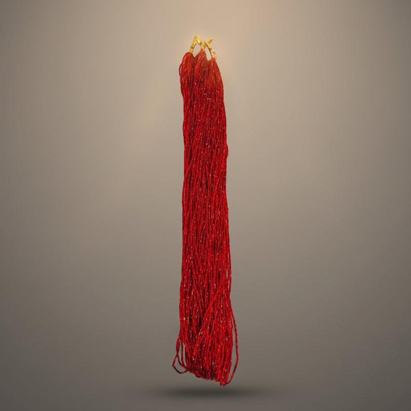 A red traditional accessory with gold-colored accents, possibly used in Nepal, displayed against a white background.