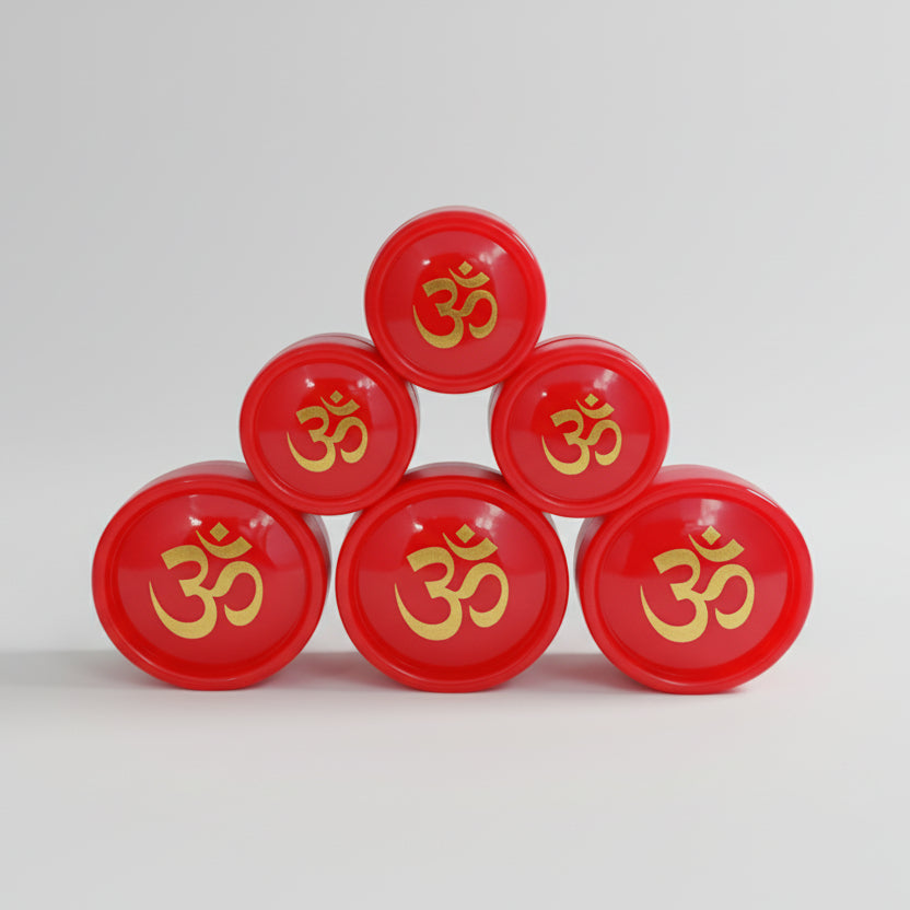 Five small red containers of Sindur powder arranged in a triangular formation on a light background, each with a golden design that resembles a OM symbol in the center.