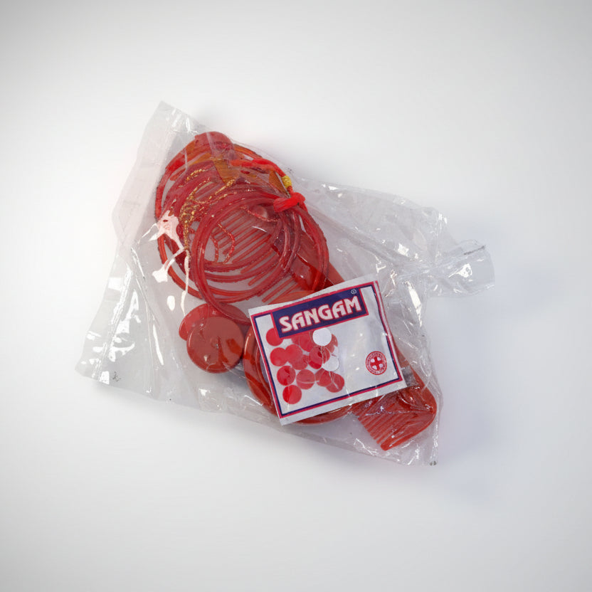 A plastic-wrapped package of Saubhagya brand party supplies, including red balloons and accessories, displayed on a white background.