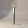 Wall-mounted light fixture with cylindrical shade on a neutral background