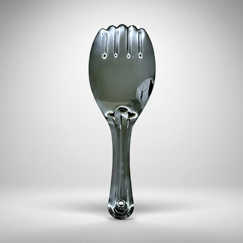Metallic spoon-like object on a gray background