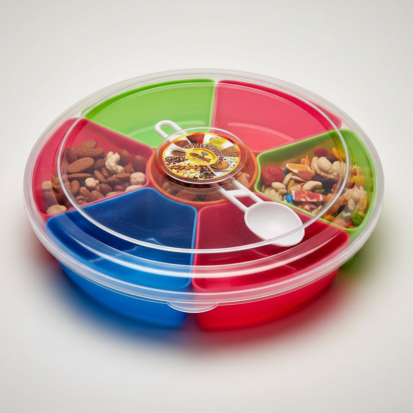 A multicolored plastic masala box with a lid, displaying red, green, and blue compartments with a white handle and a yellow lid in the center.