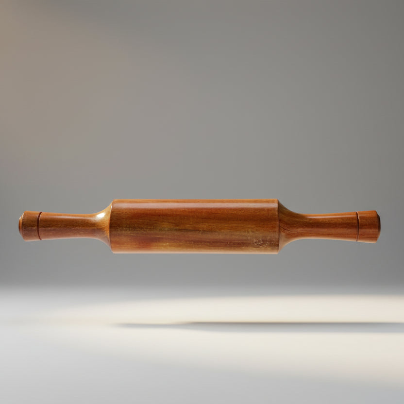 A wooden rolling pin placed on a white surface.