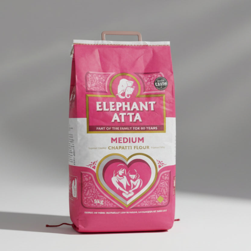 A 10kg bag of Elephant Atta medium Chapatti flour, predominantly pink in color with a white and gold heart shape design featuring an elephant.