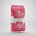 A 5kg bag of Elephant Atta Medium Wheat Flour, predominantly pink in color with a gold heart and the product name displayed prominently.