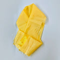 A yellow traditional fabric accessory, possibly a khada, laid flat with a visible fringed end.