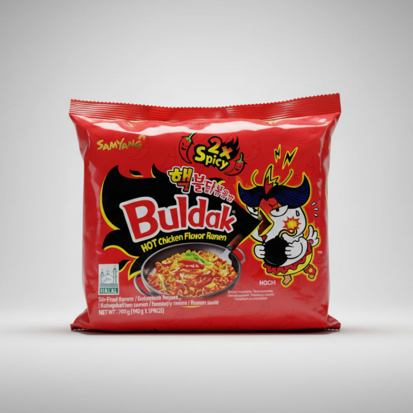 Packaging of Buldak Noodles Red with a cartoon character depicted on the front and text indicating '100% Chicken Flavor'.