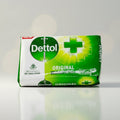 Dettol soap bar packaging on a reflective surface with a neutral background