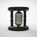 A Buddhist prayer wheel with silver-colored metal casing, placed on a dark wooden stand.